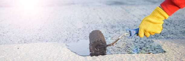 istock Worker applies bitumen mastic on the foundation 1226918104