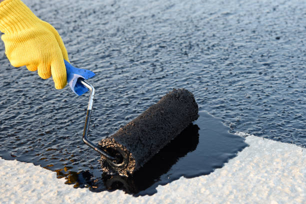 istock Worker applies bitumen mastic on the foundation 1226918137