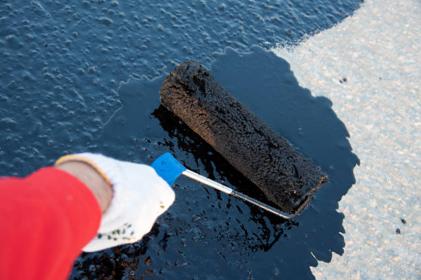 istock Worker applies bitumen mastic on the foundation 1226918140