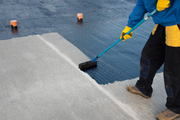 istock Worker applies bitumen mastic on the foundation 1226918220