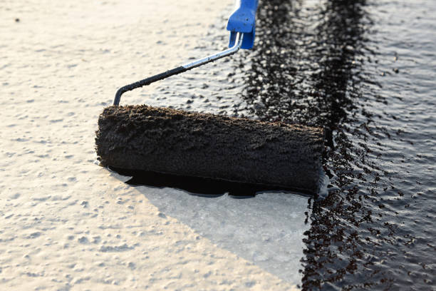 istock Worker applies bitumen mastic on the foundation 1226918291
