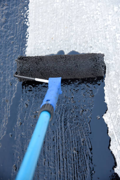 istock Worker applies bitumen mastic on the foundation 1226918318