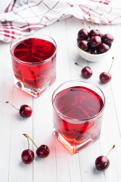 istock Cherry juice in glass glasses with fresh cherry berries. White background. copy space. 1226918336