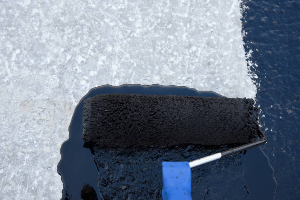 istock Worker applies bitumen mastic on the foundation 1226918485
