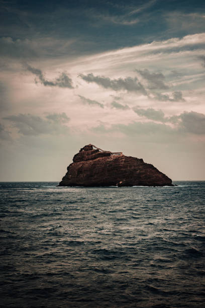 istock Rocky Atlantic shoreline under dramatic cloudscape. Sunrise on Cape Verde. View from the sea 1226922286
