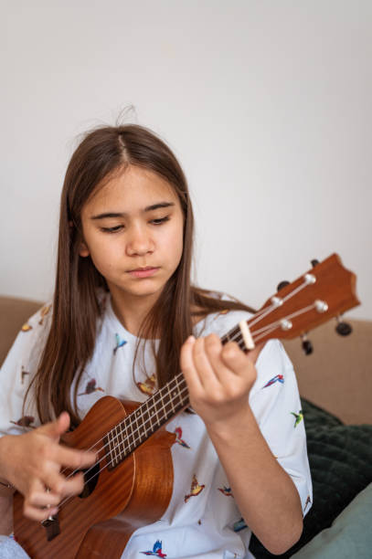 istock Young girl playing ukulele 1226925030