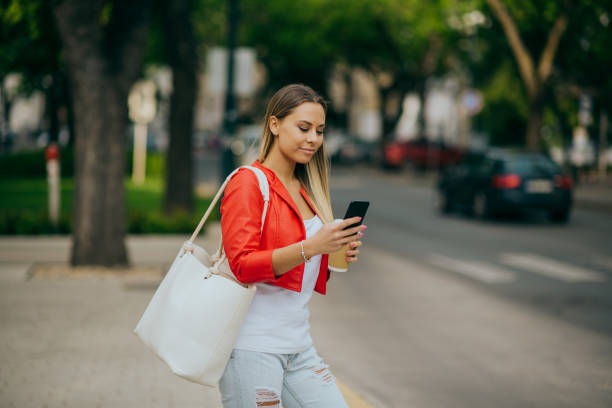 istock Woman using smartphone in the city 1226926252
