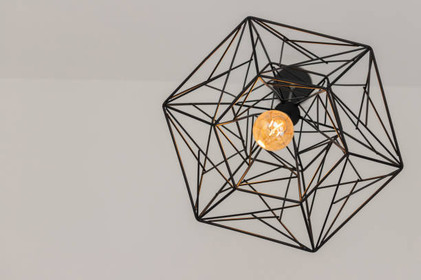 istock vintage light bulb with black steel wire lamp on white ceiling. hanging lamp. 1226926318
