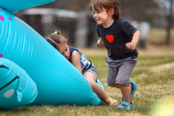 istock Brother and sister playing with a giant blown monster 1226927349