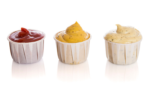 Set of three sauces, red tomato, mustard and bearnaise in recyclable paper cups, isolated on white background.