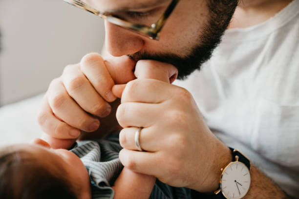 istock Father is kissing his son little hands 1226930781