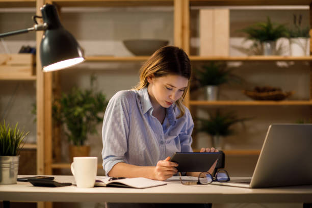 istock Young woman working from home late at night 1226930985