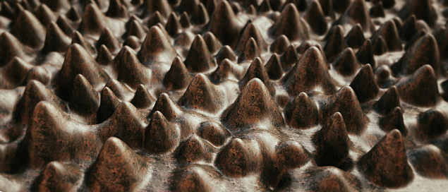 Macrophotography close-up on artificial cone shaped structure with a rough brown rusty surface