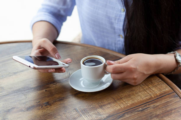 istock woman hand phone and coffee in cafe 1226932219