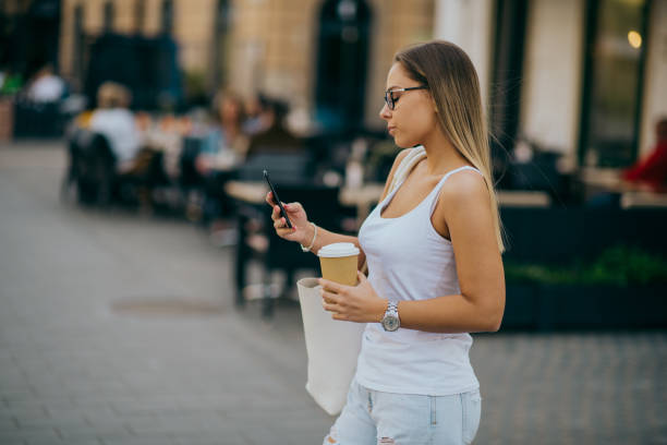 istock Woman using smartphone in the city 1226933588