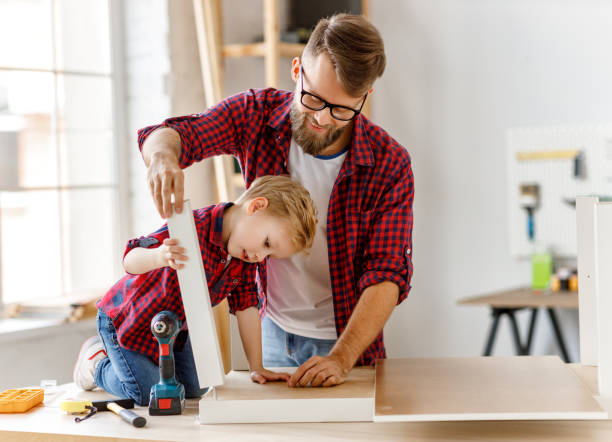istock Happy father and son assembling furniture on table 1226936046