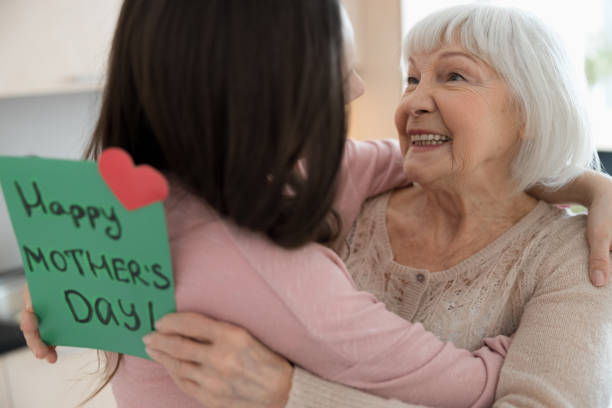 istock Cheerful elderly lady looking at her loving daughter 1226936369