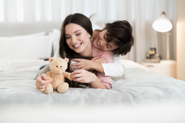 istock Dark-haired boy hugging his happy female parent 1226936394