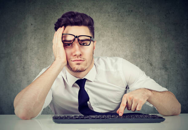 istock bored man employee sitting at desk has no motivation to work 1226936630