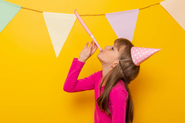 istock Child blowing party whistle while celebrating birthday 1226937906