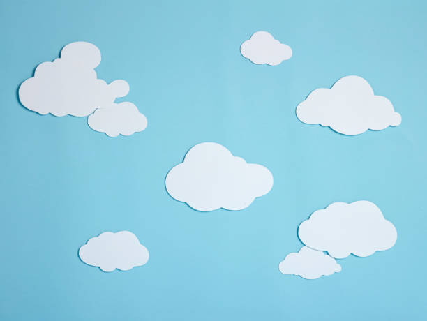 istock White paper clouds on blue paper background 1226940063