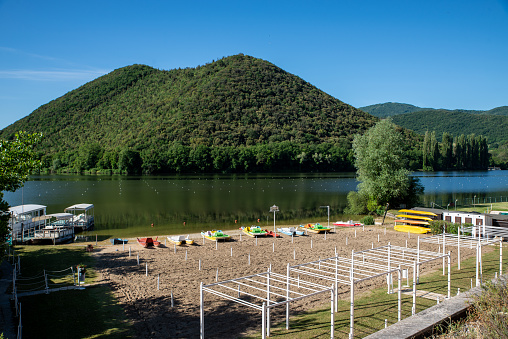 piediluco lake with view of the island in the middle of the lake and beach front with sand