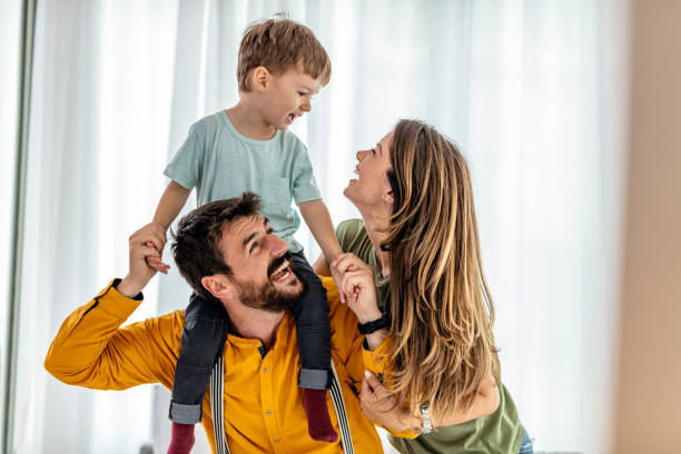 istock Cheerful Couple Playing With Son At Home 1226941292