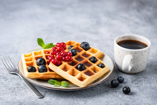 istock Belgian waffles with berries and cup of coffee 1226942541