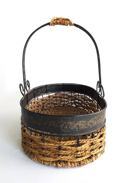 Old wrought iron and wicker basket isolated on white background. Steel Oval egg storage basket.