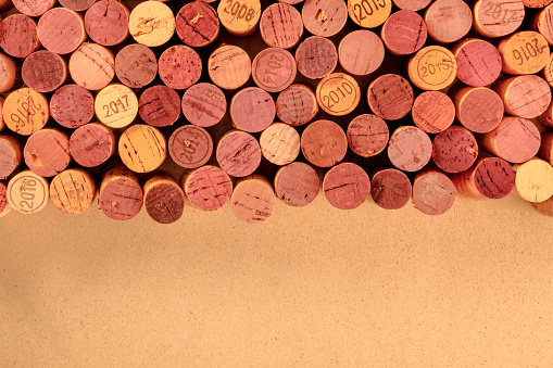 Wine corks background, a design template for a restaurant banner or tasting invitation, shot from above with copy space, toned image