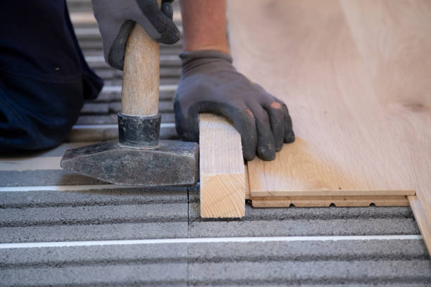istock Hand of a man is laying and installing solid parquet above underfloor heating 1226948542