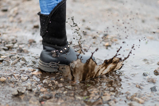 istock Children's dirty boot in a puddle. 1226949565