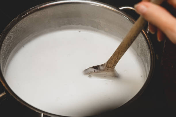 istock Fresh cheese making step by step, heating milk into a saucepan, homemade cottage cheese or paneer 1226950969