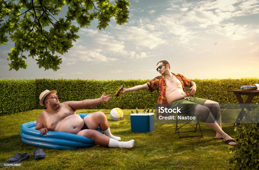 Two funny nerds relaxing in the backyard on the summer day Humor Stock Photo
