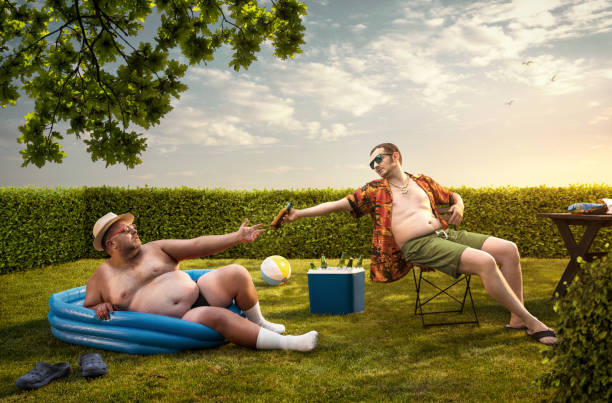 Two funny nerds relaxing in the backyard on the summer day Two funny nerds relaxing in the backyard on the summer day back yard stock pictures, royalty-free photos & images