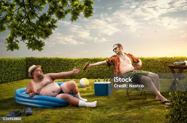 Two Funny Nerds Relaxing In The Backyard On The Summer Day Stock Photo - Download Image Now