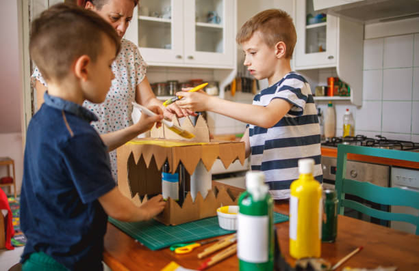 istock Brothers painting a cardboard dinosaur costume 1226954739