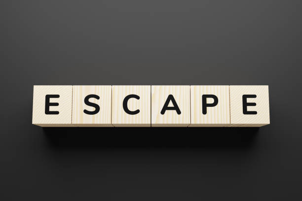 istock ESCAPE word written on blocks wooden, blocks on gray background. 1226955005