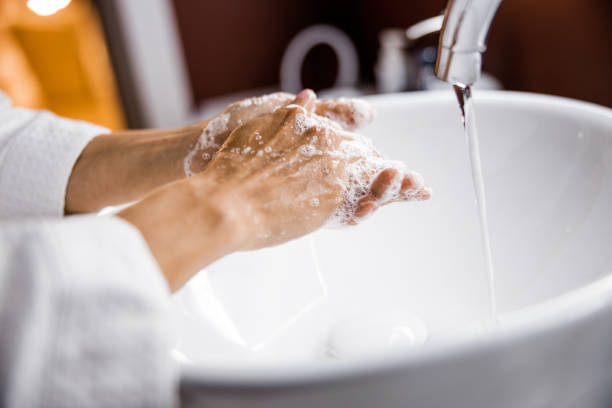 istock Female cleaning hands with foam in bathroom 1226955734