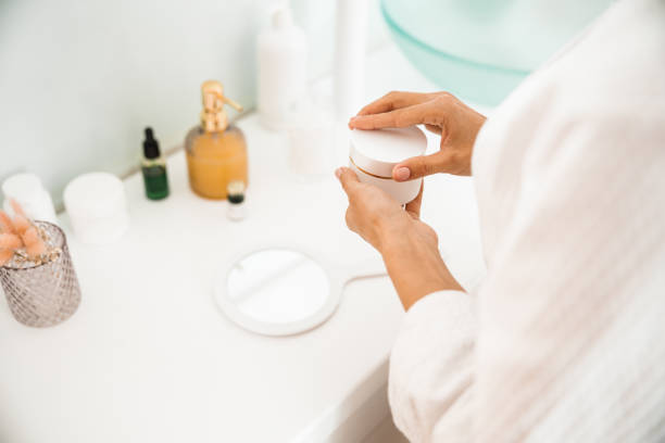 istock Female using morning face cream under sink 1226955780