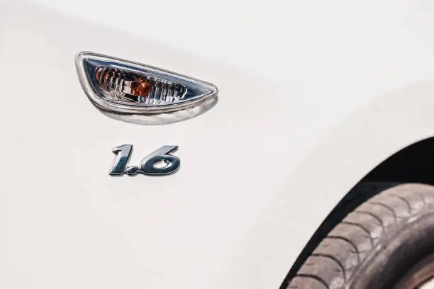 1.6 liter or 1,600 cubic centimeters plate - engine size is shown on a white car