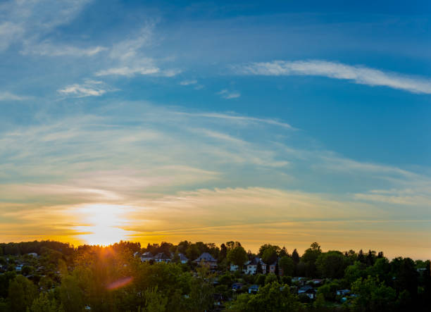 Landscape panorama of a sunset over the town hill during a spring season day.