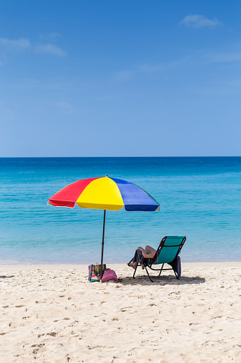 Relaxing on the beach, summer break, vacation time, colorful umbrella on beautiful beach, summer outdoor day light