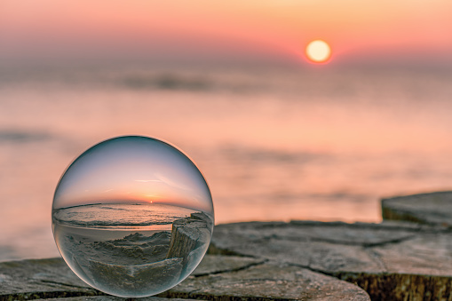 fantastic sunrise on the Baltic Sea photographed through a glass ball
