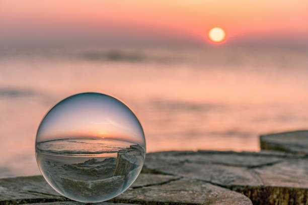 dreamlike sunrise on the Baltic Sea photographed by a glass ball stock photo