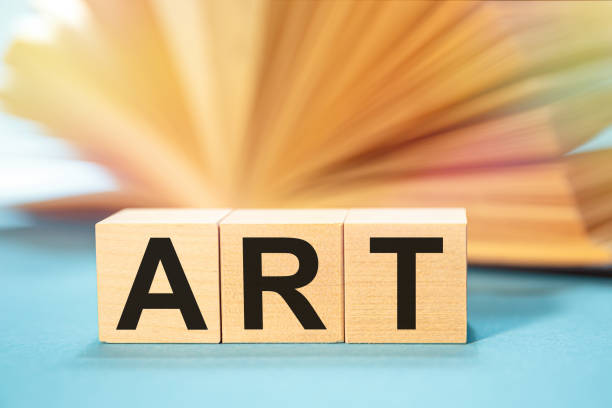 istock Open book and Wooden cubes with the abbreviation ART 1226963276