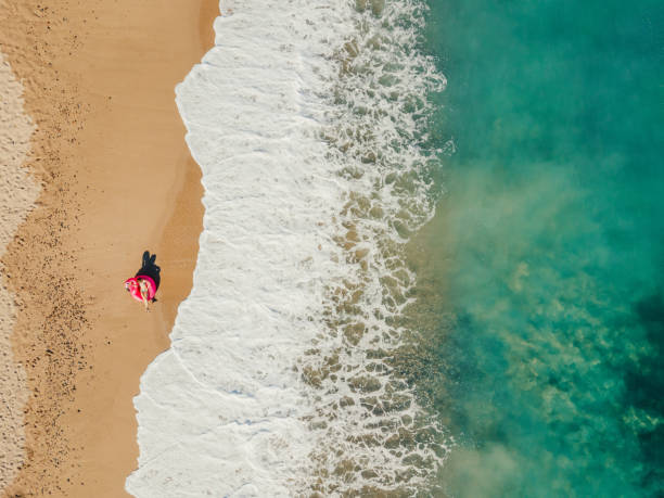 istock Happy woman relaxing on the beach 1226963509