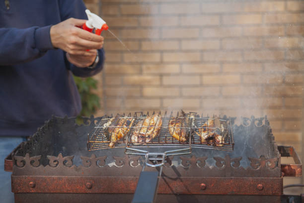 istock Pouring mackerel roasting on grill with water from spray bottle 1226964866