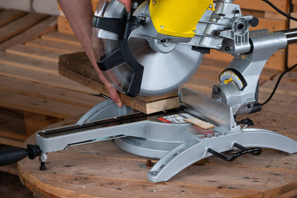 istock miter saw for cutting a tree on a wooden table. Tool for carpentry. A man works with a tool. 1226965384