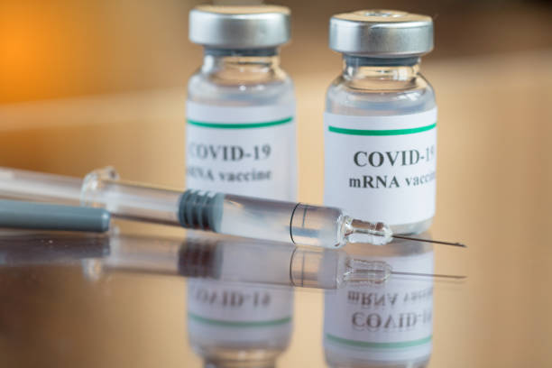 istock COVID-19 mRNA Vaccine and syringe with needle injection 1226967866